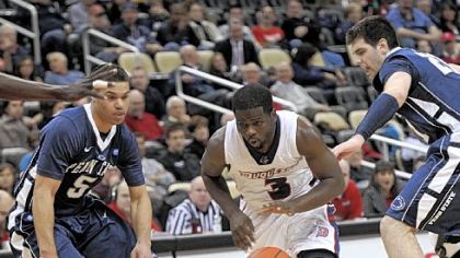 Duquesne's Eric Evans, right, drives on Penn State's Matt Glover. Evans had 20 points in the Dukes' win.