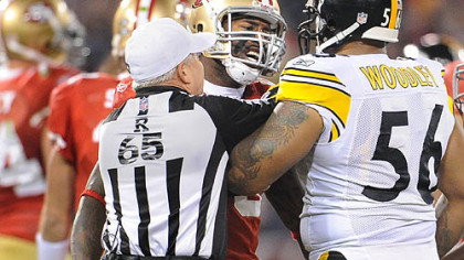 49ers Vernon Davis goes face to face with Steelers LaMarr Woodley during Monday night's game at Candlestick Park.