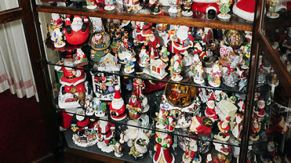 The display case in Carol Vicini's home showcases about 400 Santa figures from around the world. Some were made by Lennox and Goebel.