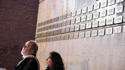 Mac McMahon, left, and Linda Sheets sing "Amazing Grace" at a candlelight vigil to remember the homeless who died while on the streets this year at the Grant Street memorial on Wednesday. Ms. Sheets works for Pittsburgh Mercy Health System and Mr. McMahon works for Community Human Services.