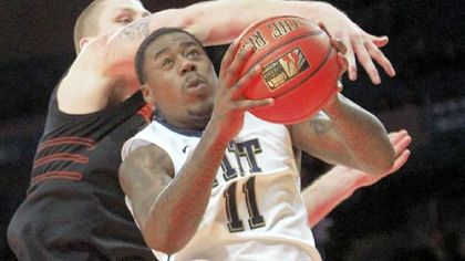 Dante Taylor slips under Oklahoma State's Philip Jurick for a shot Saturday.