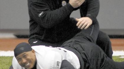 Who knew stretching could be so much fun? Steelers receiver Hines Ward gets some help from a member of the team's training staff before practice Wednesday at the team's South Side facilities.
