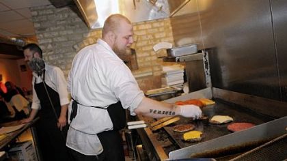 Zachary Winghart works the grill at Winghart's Burger & Whiskey Bar in Market Square.