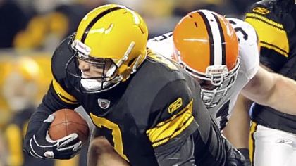 Ben Roethlisberger's left foot is twisted underneath Browns defensive lineman Scott Paxson in the second quarter Thursday. Roethlisberger left the game but returned to start the second half.
