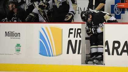 Sidney Crosby bends over in pain on the bench in the third period Monday after colliding with teammate Chris Kunitz. Crosby returned to the game against the Bruins, but was given a maintenance day at practice Tuesday. He is expected to practice today.