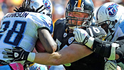 Chris Hoke is makes tackle on the Titans Chris Johnson in an Oct. 9 game. Hoke will undergo neck surgery and be out for the year. It may also end his career.