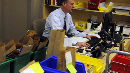Louis Zangara, pharmacist for The Center for Pharmacy Services in the Hill District, fills a prescription Thursday. The pharmacy, run by Duquesne University, is the country's only stand-alone pharmacy run by a university.