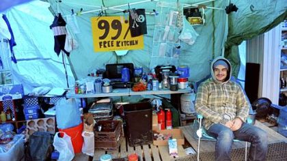 Occupy Pittsburgh protester Mike Klaiber of the South Side sits inside the kitchen tent at Mellon Green on Grant Street, Downtown, on Friday. The group plans to begin winterizing its encampment this weekend.