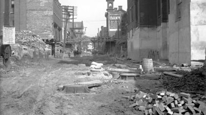 The cupola or belfry of Hancock School, on the right side of Webster Avenue, appears in this September 1912 photograph taken during the "hump cut," when Grant's Hill was excavated to make the area level with surrounding streets. The building in the right foreground was part of the St. Mary's school and church complex.