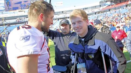 Denver Broncos quarterback Tim Tebow, left, meets with Jacob Rainey before a game against the Buffalo Bills Saturday in Orchard Park, N.Y. Rainey, a junior at Woodberry Forest School in Orange, Va., had a portion of his right leg removed after sustaining a severe knee injury Sept. 3 in a football scrimmage.