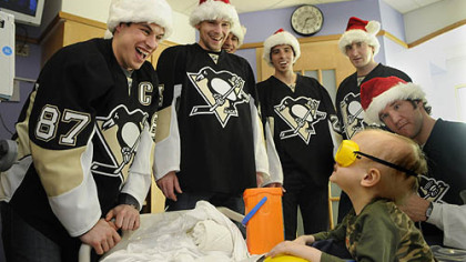 Camden Lookabaugh, 3, smiles at members of the Pittsburgh Penguins team after Sidney Crosby put toy safety goggles on him. Camden is a patient at Children's Hopsital of Pittsburgh of UPMC and received a toy tool box from the Penguins, who were visiting the hospital.  Along with Crosby is Zbynek Michalek, Evgeni Malkin, Marc-Andre Fleury, Brooks Orpik and Steve MacIntyre.