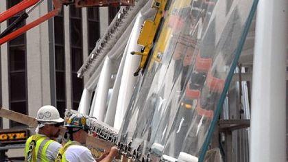 Workers install a panel at the entrance to the new Gateway Station on Stanwix Street. The subway spur line is expected to be riding the rails sometime in March.