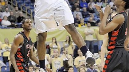 J.J. Moore dunks for two of his team-high 15 points Tuesday night against Saint Francis.