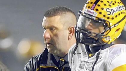Montour coach Lou Cerro consoles Devin Wilson after losing to Bishop McDevitt in a PIAA Class AAA semifinal Friday night at Mansion Park Stadium in Altoona.