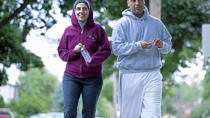 Nawal Aoude, a pediatric respiratory therapist, and her husband Nader go for a walk in a scene from the TLC series, "All-American Muslim."