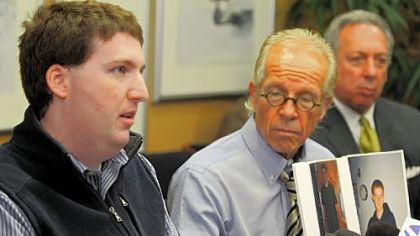 Zachary R. Tomaselli, left, reads a statement regarding his civil suit against Bernard Fine as he speaks to reporters with his lawyers, Jeff Anderson and Alan H. Perer.