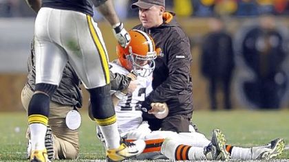 Browns quarterback Colt McCoy is attended to after taking a hit from James Harrison.