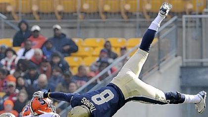 Pitt's Todd Thomas goes airborne to put pressure on Syracuse quarterback Ryan Nassib early in the home finale Saturday at Heinz Field. The Panthers defeated the Orange, 33-20, to finish 6-6.