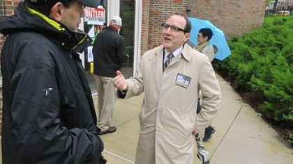 Marty Childs of Squirrel Hill listens to Councilman Doug Shields as he campaigns at the Colfax Elementary School.