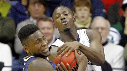 Pitt's Talib Zanna wrestles with Notre Dame's Jerian Grant for a loose ball in the second half Tuesday night. Zanna led the Panthers with 13 points and 12 rebounds.
