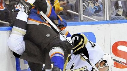 Paul Martin and New York's Tim Wallace get tangled along the boards Saturday night in the Penguins' 6-3 victory against the Islanders in Uniondale, N.Y.