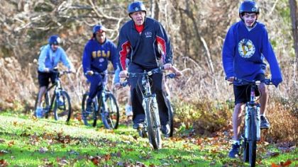 Greg Laun, health and physical education teacher at Dorseyville Middle School in the Fox Chapel Area School District, leads a class of eighth-graders on a mountain bike ride around the school campus.