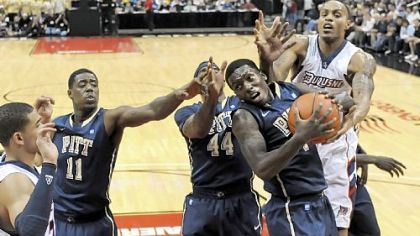 Ashton Gibbs drives on Duquesne's Andre Marhold for two of his team-high 18 points for Pitt.