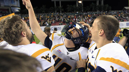 West Virginia's Tyler Bitancurt (40) celebrates with teammates after kicking the game-winning field goal in West Virginia's 30-27 win over South Florida last night in Tampa.