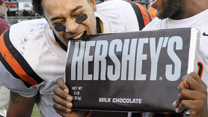 Clairton's Dakota Halcomb bites a large Hershey's bar after defeating Southern Columbia at Hersheypark Stadium.