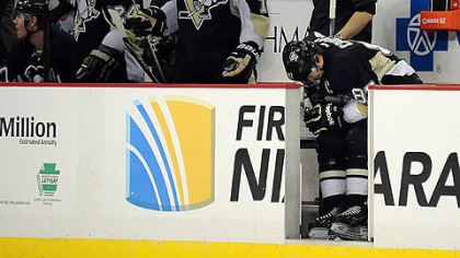 Penguins captain Sidney Crosby sits in pain on the bench in a game last week against Boston.