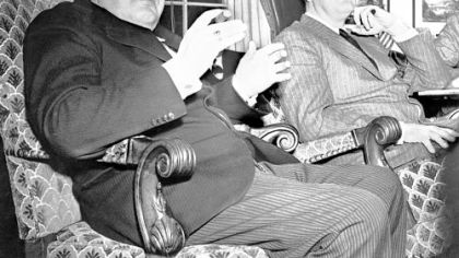 British Prime Minister Winston Churchill and President Franklin Roosevelt, at a White House news conference on Dec. 23, 1941,  expressed confidence in victory in WWII. Churchill used his customary black cigar to emphasize his comments.