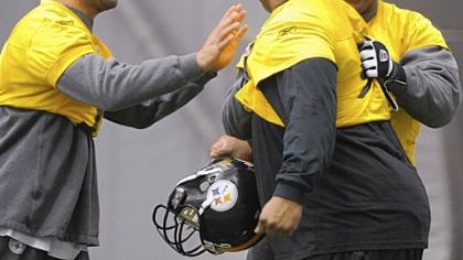 Larry Foote, left, James Harrison, right, joke with Casey Hampton before the start of practice Wednesday at the South Side facilities.