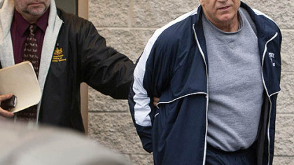 Former Penn State assistant football coach Jerry Sandusky, right, leaves the office of Centre County District Justice Daniel A. Hoffman on Wednesday under escort by Pennsylvania State Police and Attorney General's Office officials in Bellefonte, Pa.  Mr. Sandusky was arrested and jailed Wednesday on new child sex abuse charges brought by two new accusers, including one who claims Mr. Sandusky molested him numerous times in a basement bedroom, according to authorities.