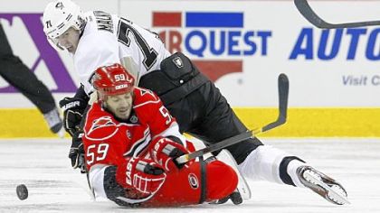 Evgeni Malkin scraps for the puck with Carolina's Jeff Skinner in the second period of the Penguins' 3-2 victory Saturday night in Raleigh, N.C.