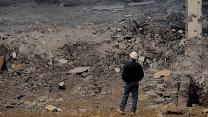 A construction worker stands on the floor of the Civic Arena looking west.