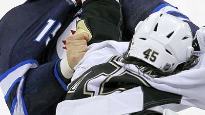 Jets forward Tanner Glass and Penguins forward Arron Asham (45) fight in the first-period Friday in Winnipeg, Manitoba.