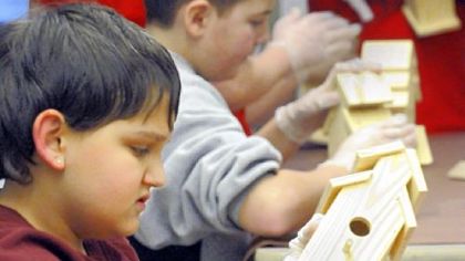 Patrick Worrall, 12, works on his birdhouse.