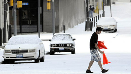 Orange cones to mark a pedestrian crossing are put down at Oliver Avenue and William Penn Place after a blanket of fake snow turns a Downtown Pittsburgh street into Gotham in winter.