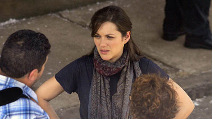 Marion Cotillard, who plays Miranda Tate, waits for a scene to be filmed.
