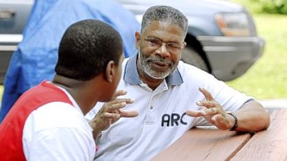 Daniel Elby, right, CEO of Alternative Rehabilitation Communities, speaks with student Danny R. outside the A.R.C. Woodland home in Harrisburg. The agency's residential program for dependent and delinquent youth has been called a model to follow.