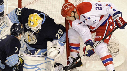 The Penguins' Marc-Andre Fleury stops a shot by the Capitals' Mike Knuble in the first period at the Winter Classic at Heinz Field last night.