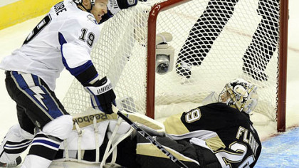 Penguins goaltender Marc-Andre Fleury makes a save on Lightning center Dominic Moore in the first period Wednesday at Consol Energy Center.
