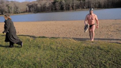 Kathy Olek, left, bundles up as Darren Miller towels off after swimming in Keystone Lake at Keystone State Park in Westmoreland County. Darren is attempting to swim the "Ocean's Seven," and raise money for the cardiothoracic unit at UPMC Children's Hosptial of Pittsburgh.
