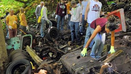 Katrina Horner of Colorado tries picking up an automoblie gas tank Tuesday as she and others work to clear debris from Heth's Run in the Morningside section.   Katrina is attending the  Mennonite Church USA Convention  and is one of more than 200 youths helping in the cleanup of the Heth's Run watershed.