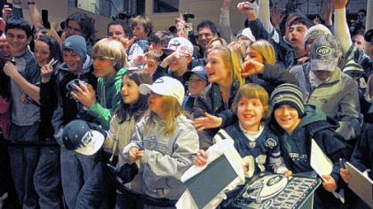 Jets fans cheer for their team in the lobby of the Westin Convention Center hotel, Downtown.