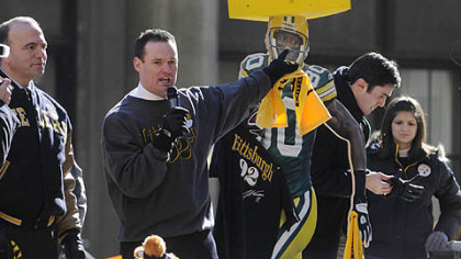 Mayor Luke Ravenstahl goads the crowd to put a foam cheese hat into a shredder.