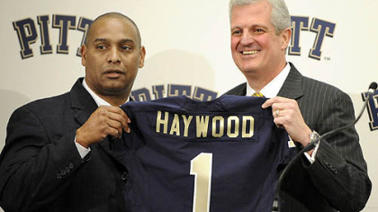 Former Pitt head coach Michael Haywood poses with athletic director Steve Pederson during a press conference Dec. 16. Haywood was fired Jan. 1.