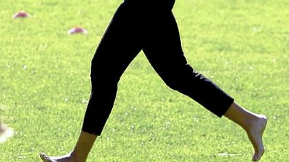 Running barefoot on the White House lawn, wearing her favorite Azzedine Alaia belt, during a healthy kids fair.