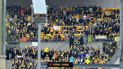 "Fans" cheer at Heinz Field as extras for the upcoming Batman movie "The Dark Knight Rises" filming at the stadium today.