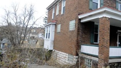 The house next door to Colleen Walters' has been vacant and unmaintained for years.